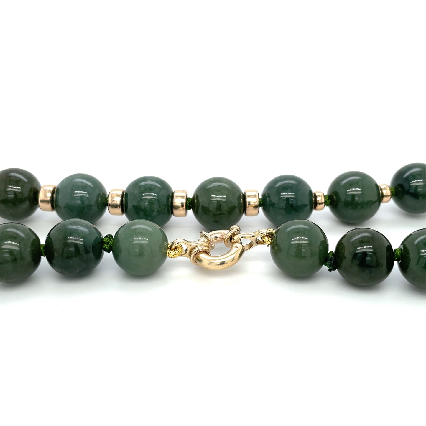 A custom jade neaclace, 13.5mm (approx) natural A grade jade beads with 9ct gold spacers and bolt-ring clasp.
