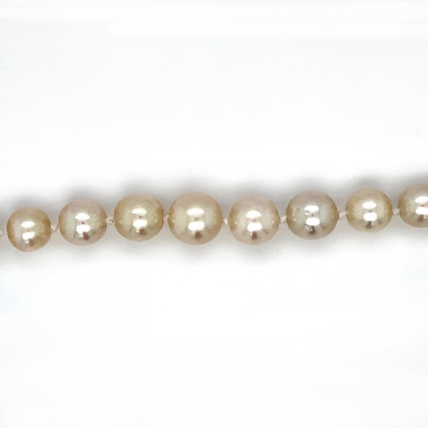 18inch cultured pearl necklace (graduating from 2.7mm - 7mm) with an 18ct white gold clasp set with an emeraldf cut emerald and bauguette and round diamonds.